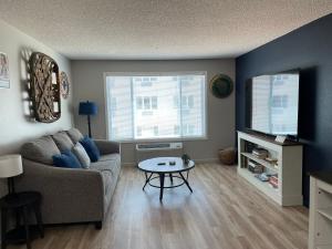 a living room with a couch and a table at Highland Estates Condotel in Mesquite
