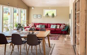 a living room with a red couch and a table at 2 Bedroom Amazing Home In Säffle in Säffle