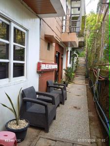 a row of chairs sitting outside of a building at Raje Residence El Nido in El Nido