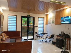 a living room with a couch and a table and chairs at Raje Residence El Nido in El Nido