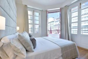 a bedroom with a bed and a large window at Hostal Zahara in Ferrol