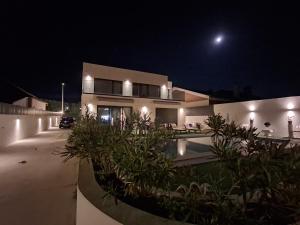 a house at night with the moon in the sky at RM MAISON by Rui & Mi in Tomar