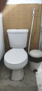 a bathroom with a white toilet and a sink at Urban Nest Hostel in Bangkok +9 photos
