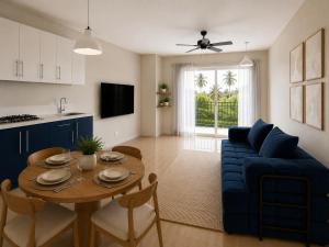 a living room with a table and a blue couch at HERGOZ Apartamentos in Cayetano Germosén