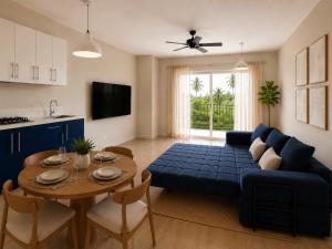 a living room with a blue couch and a table at HERGOZ Apartamentos in Cayetano Germosén