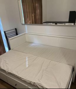 an empty bed in a room with a window at Riverside Apartment Tartu in Tartu +4 photos
