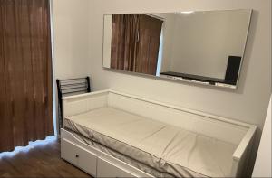 a bed in a room with a large mirror at Riverside Apartment Tartu in Tartu