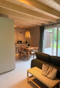 a living room with a couch and a table at Leśna Sonata in Marksoby