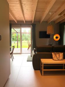 a living room with a couch and a table at Leśna Sonata in Marksoby