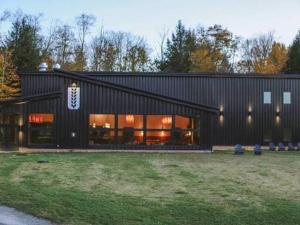 a black building with a lot of windows at Grateful Manor-Close to Downtown- Sauna in Livingston Manor