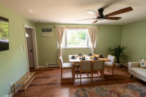 a dining room with a table and a ceiling fan at Grateful Manor-Close to Downtown- Sauna in Livingston Manor