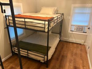 a couple of bunk beds in a room at Grateful Manor-Close to Downtown- Sauna in Livingston Manor
