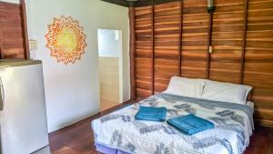 a bedroom with a bed with two towels on it at Affordable shack in Ko Yao Noi
