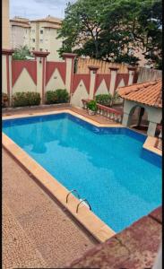 a large blue swimming pool in a building at Quefren Residence Hotel in Uberaba