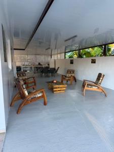 a room with chairs and a table in a room at Tevaatua house in Papara