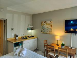 a room with a bed and a table and a kitchen at Studio in Hallandale 2270 in Hallandale Beach