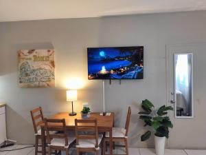 a dining room with a table and a tv on the wall at Studio in Hallandale 2270 in Hallandale Beach +1 photo