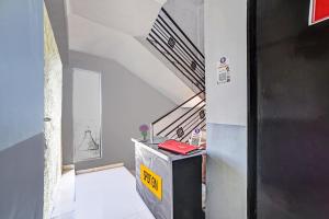 a hallway with a staircase in a house at Hotel O SS in Chandrapur