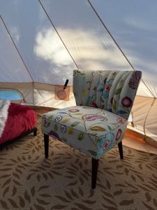 a chair in a room with a tent at Willowbank Bell Tent in Golden +20 photos