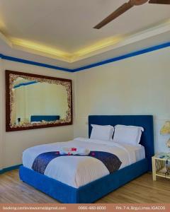 a bed with two stuffed animals on it in a bedroom at Castle View Hotel Resort in Samal