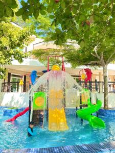 a child playing on a water slide at a water park at Castle View Hotel Resort in Samal +11 photos