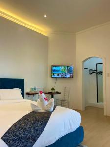 a bedroom with a bed and a table and a mirror at Castle View Hotel Resort in Samal