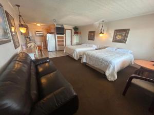 a hotel room with two beds and a couch at Seven Seas in Kure Beach