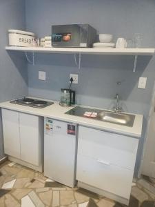 a kitchen with a sink and a counter top at Lifeshed in Johannesburg