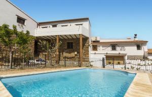 a swimming pool in front of a house at Los Moreno in Laroya