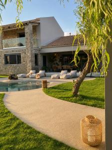 a house with a walkway in front of a building at Villa Tartaya Boutique Villa with Private Pool in Corfu in Dassia