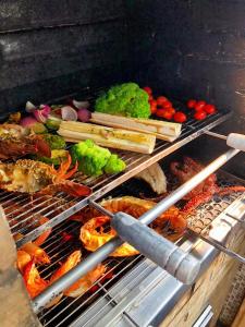 a grill with many different types of food on it at Búzios House Oficial in Búzios
