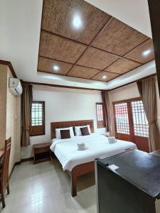 a bedroom with a large white bed in a room at Fueangfu Pool Villa Chaweng in Chaweng +51 photos