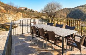 a table and chairs on a patio with a fence at Yerbaluisa in Laroya