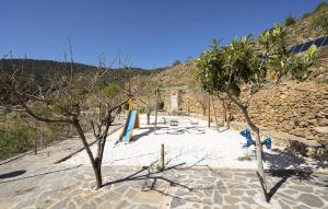 a beach with trees in the sand and a building at Yerbaluisa in Laroya +10 photos