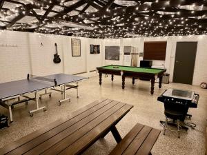 a ping pong room with two ping pong tables at Hunter Valley 2 x Homes Pets Heated Pool in Whittingham