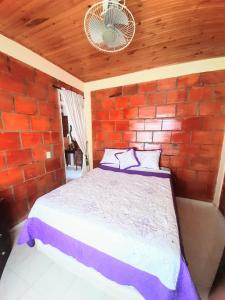 a bedroom with a bed in a brick wall at Casa Vacacional Algarrobos in Girardot +11 photos