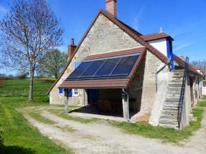 a barn with a large window on the side of it at Éco-gîte rénové avec wifi près de Vichy - FR-1-489-290 in Bransat