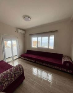 a large bed in a room with a large window at اقامة حسن الجوار in Oran