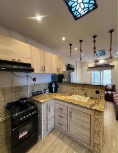a kitchen with a stove and a counter top at اقامة حسن الجوار in Oran