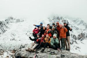 a group of people posing for a picture on a mountain at Colpapampa Lodge in Colcapampa