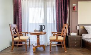 a room with a table and two chairs and a bed at Mobydick Hotel in Yangyang