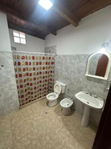 a bathroom with a toilet and a sink at aura in La Falda