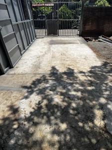 a shadow of a tree on a sidewalk next to a gate at Casa Aquino in Santa Cruz Analquito