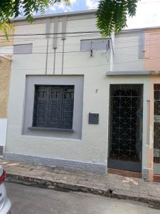 a white building with two doors on a street at CASA EXPO CRATo in Crato +7 photos