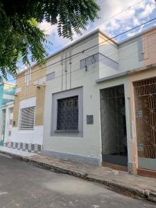 a white building on the side of a street at CASA EXPO CRATo in Crato
