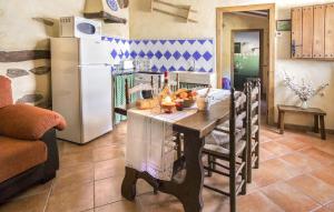 a kitchen with a table and a refrigerator at Jaraiz in Laroya