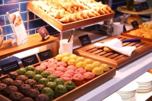 a display case with various types of bread and pastries at Hotel Springs Makuhari Premier in Chiba