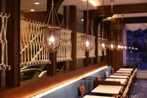 a row of tables and lights in a restaurant at Hotel Springs Makuhari Premier in Chiba