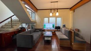 a living room with a couch and a tv at 88 Ehome Noibai Airport in Hanoi
