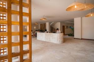 a lobby with a bar in the middle of a building at Be caju flats in Barra Grande +83 photos